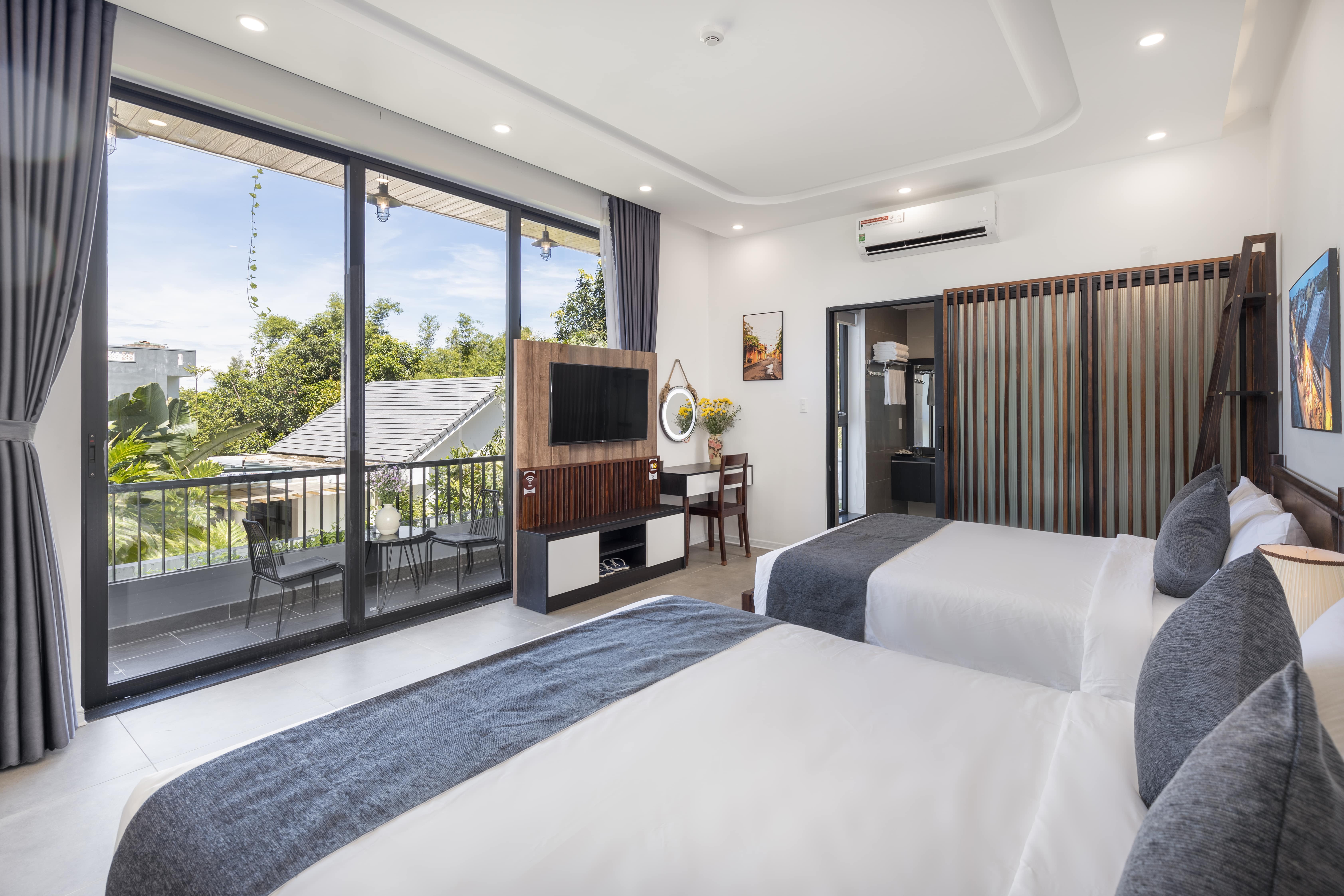 Deluxe family room with balcony and garden view.